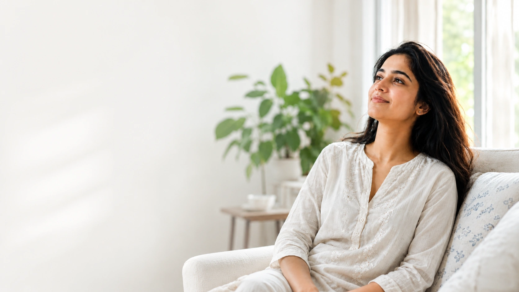 A woman smiling, looking toward the light